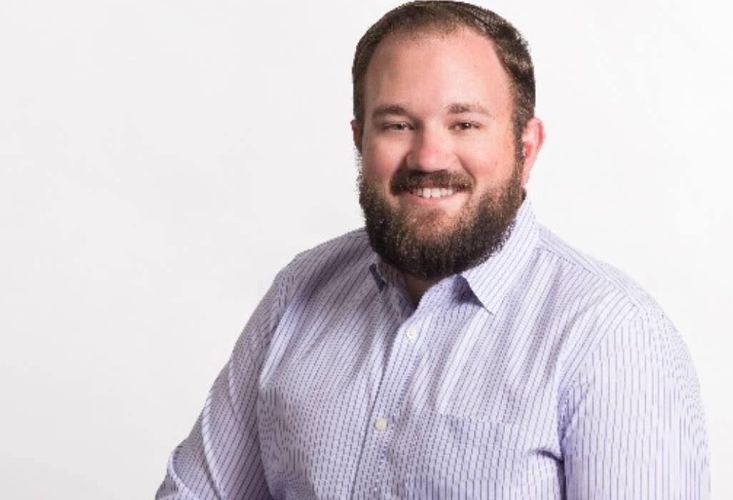 Kyle Mark smiling on white background
