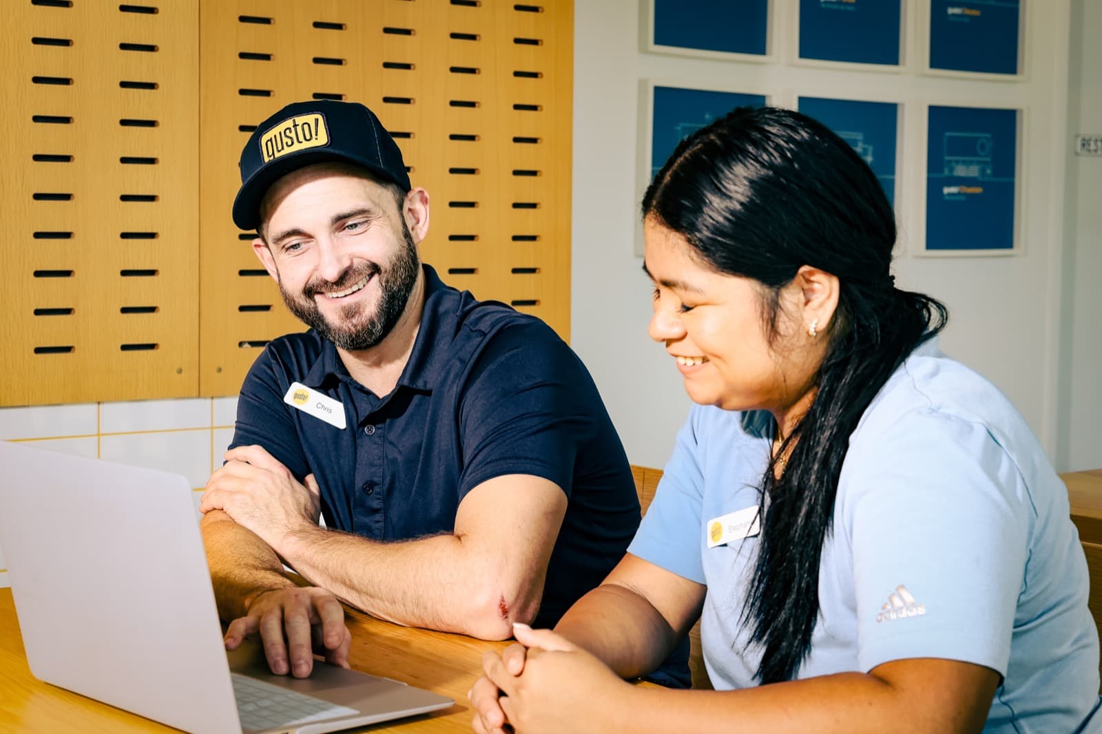 A restaurant manager training a new employee on the floor