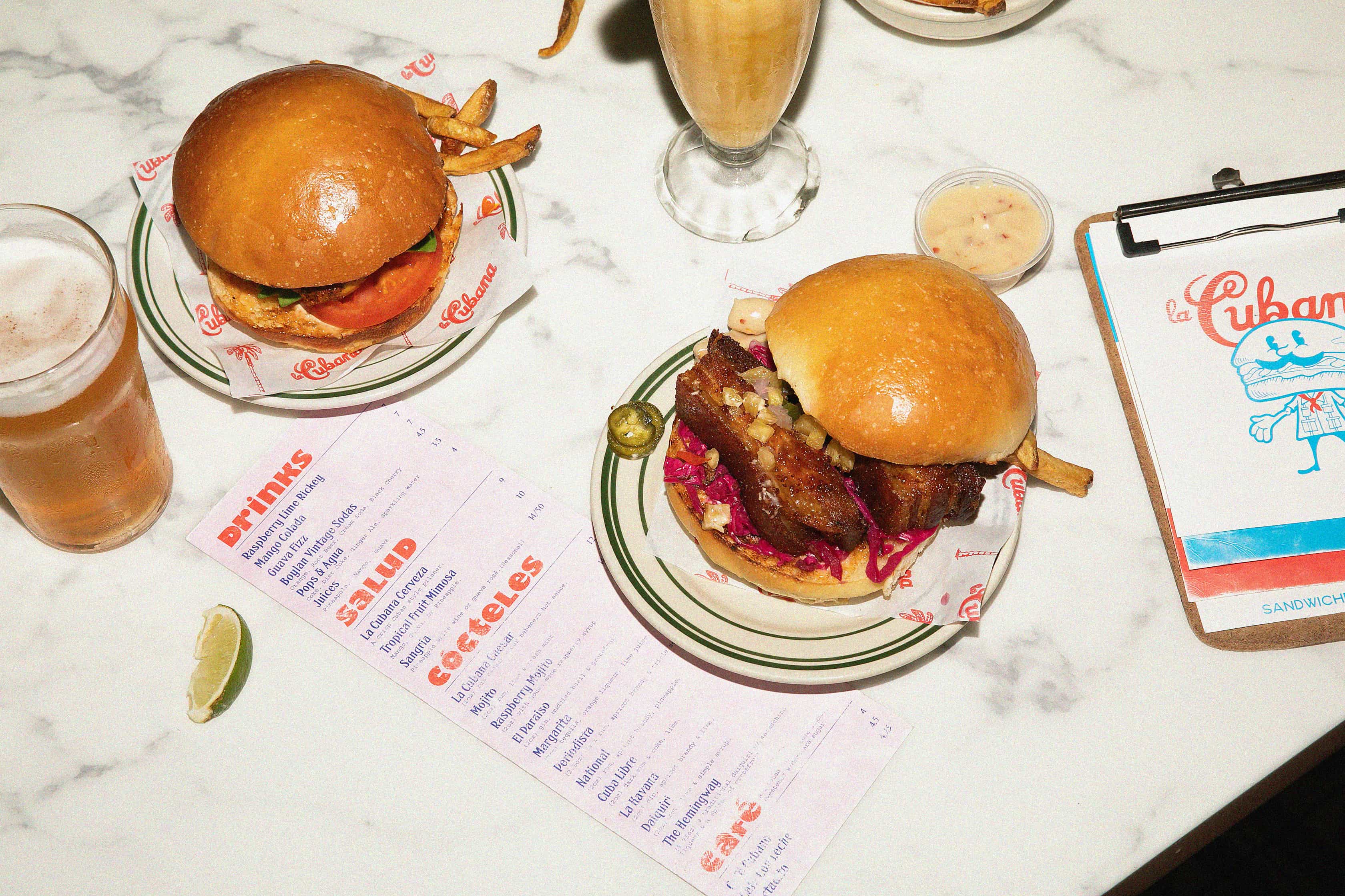Veggie pizza being placed in a brick oven with flames in the background