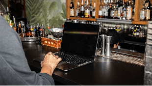 Laptop open on a bar top