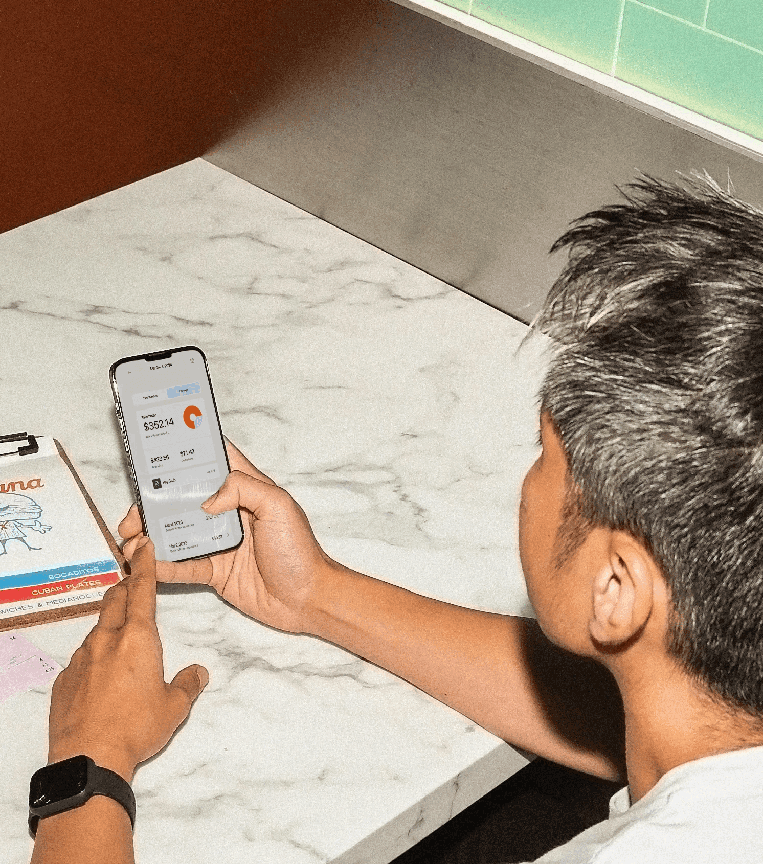 Restaurant worker checking their pay on the 7shifts app