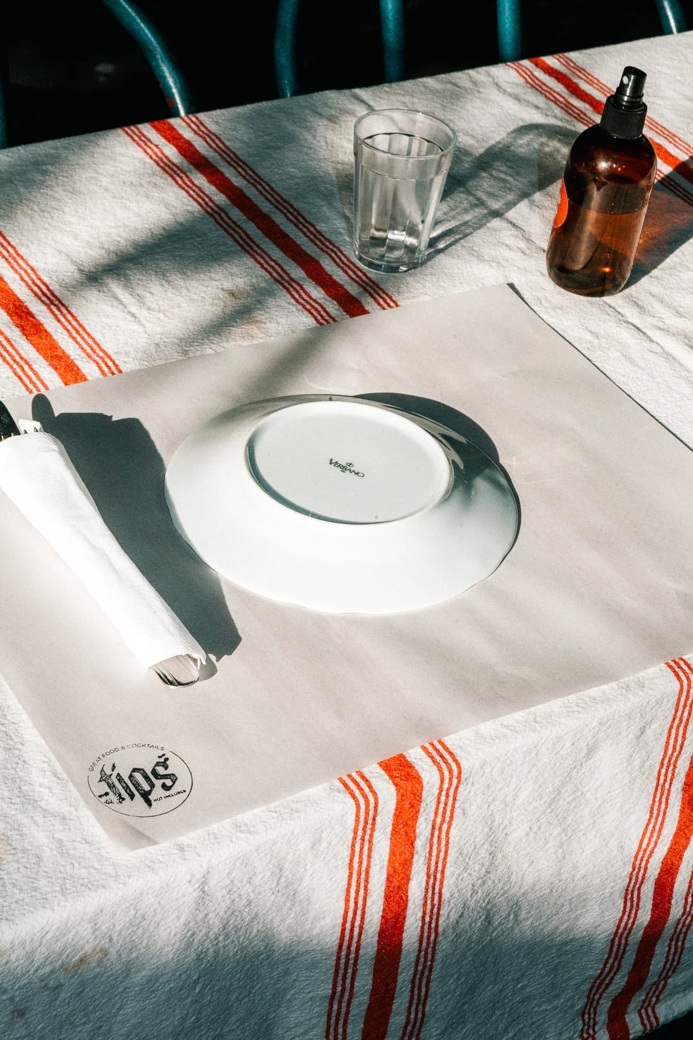 Table setting with plate, napkin, glass, and bottle