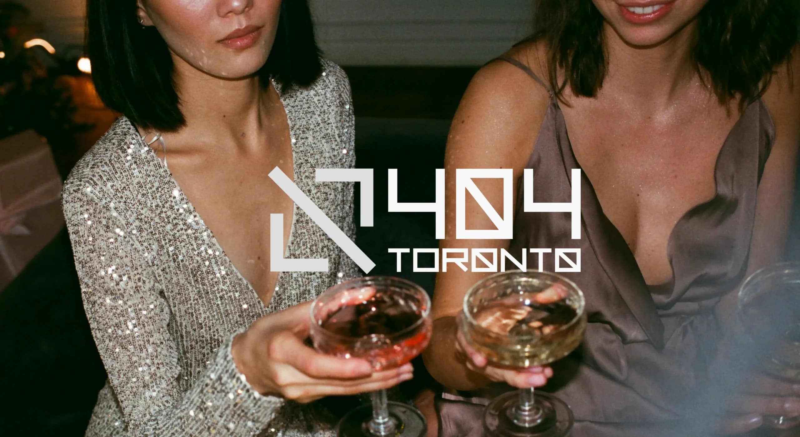 Women enjoying cocktails at a bar, 404 Toronto logo overlay on top