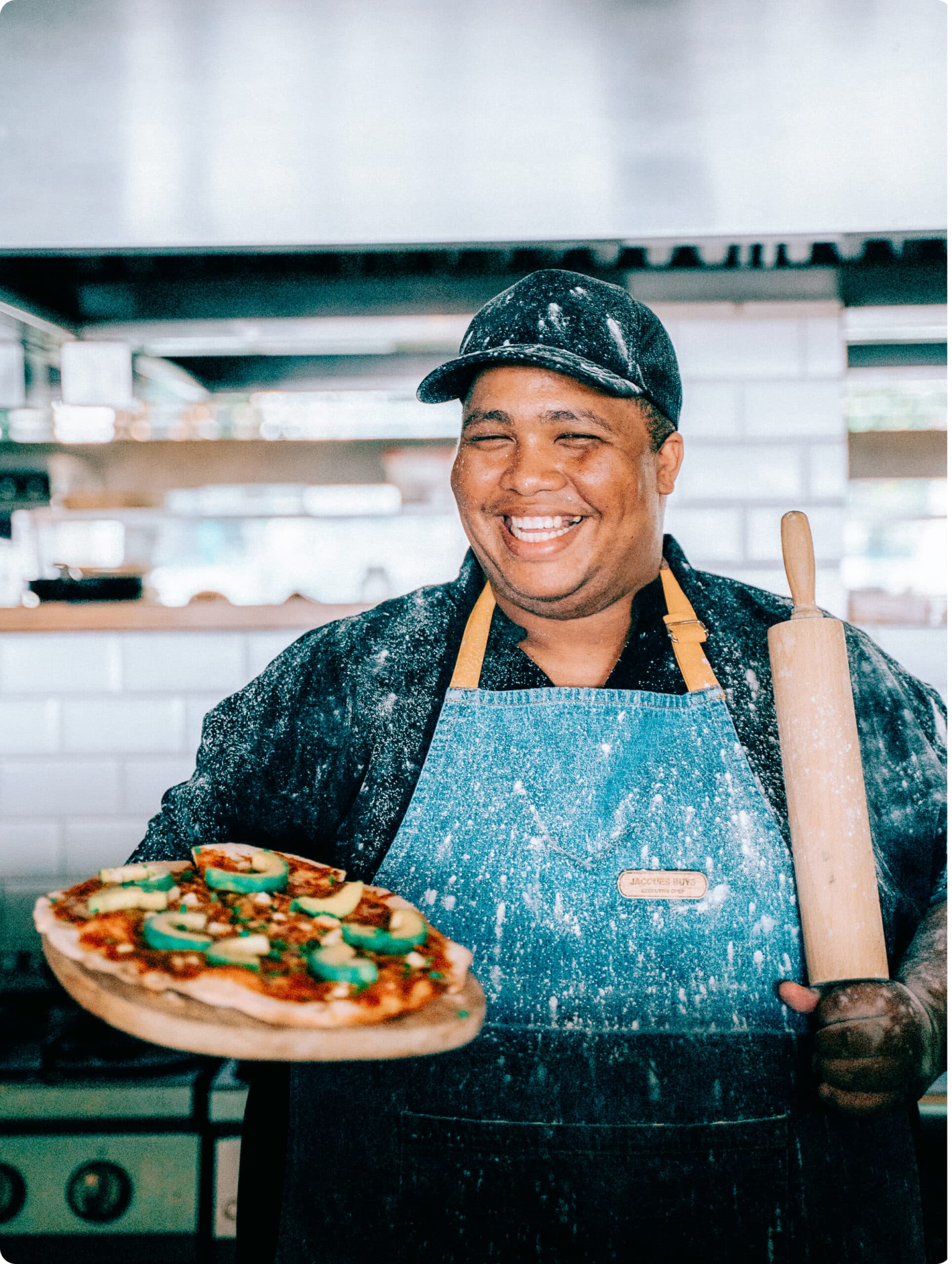Chef smiling making pizza
