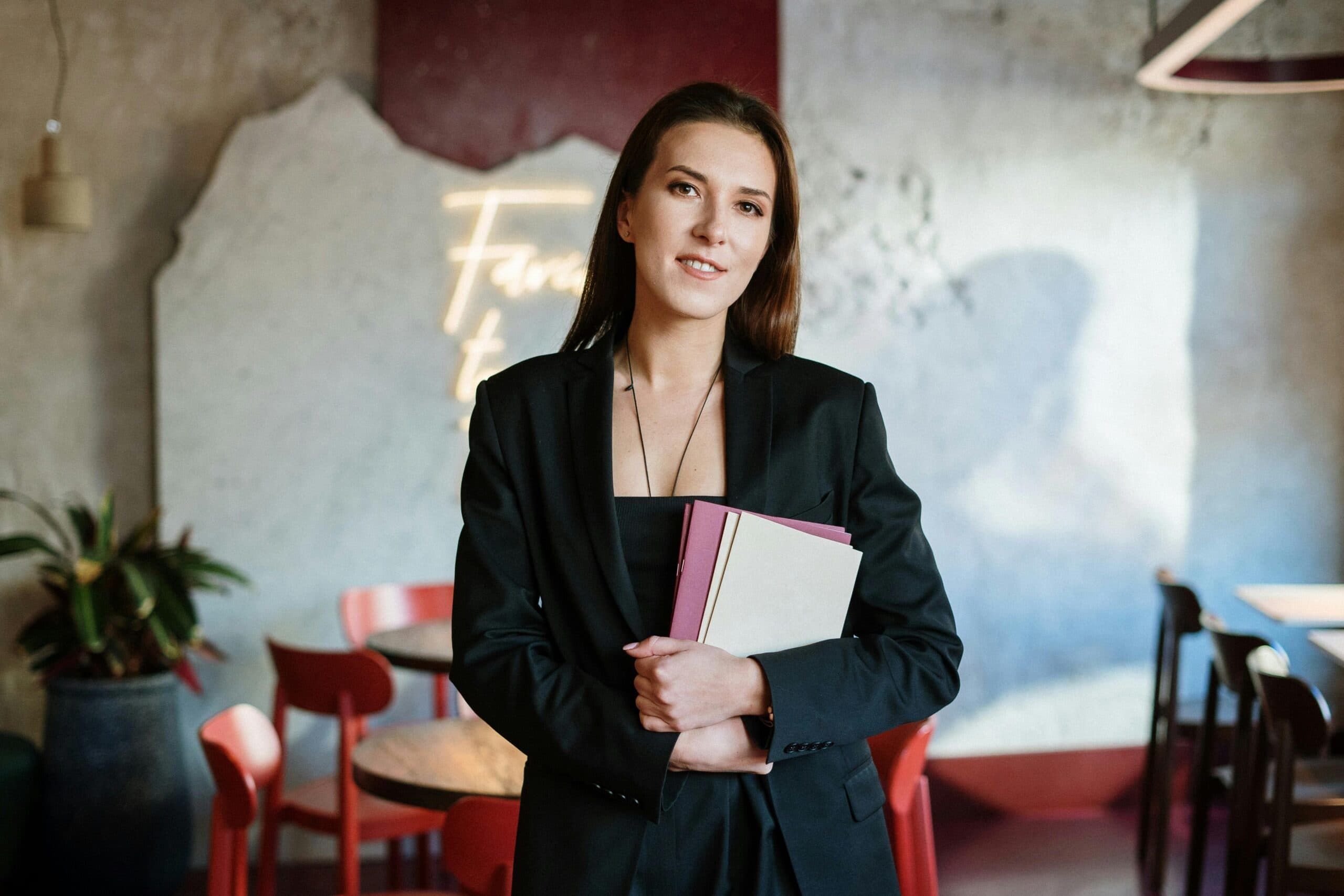 Woman restaurant owner holding a clipboard