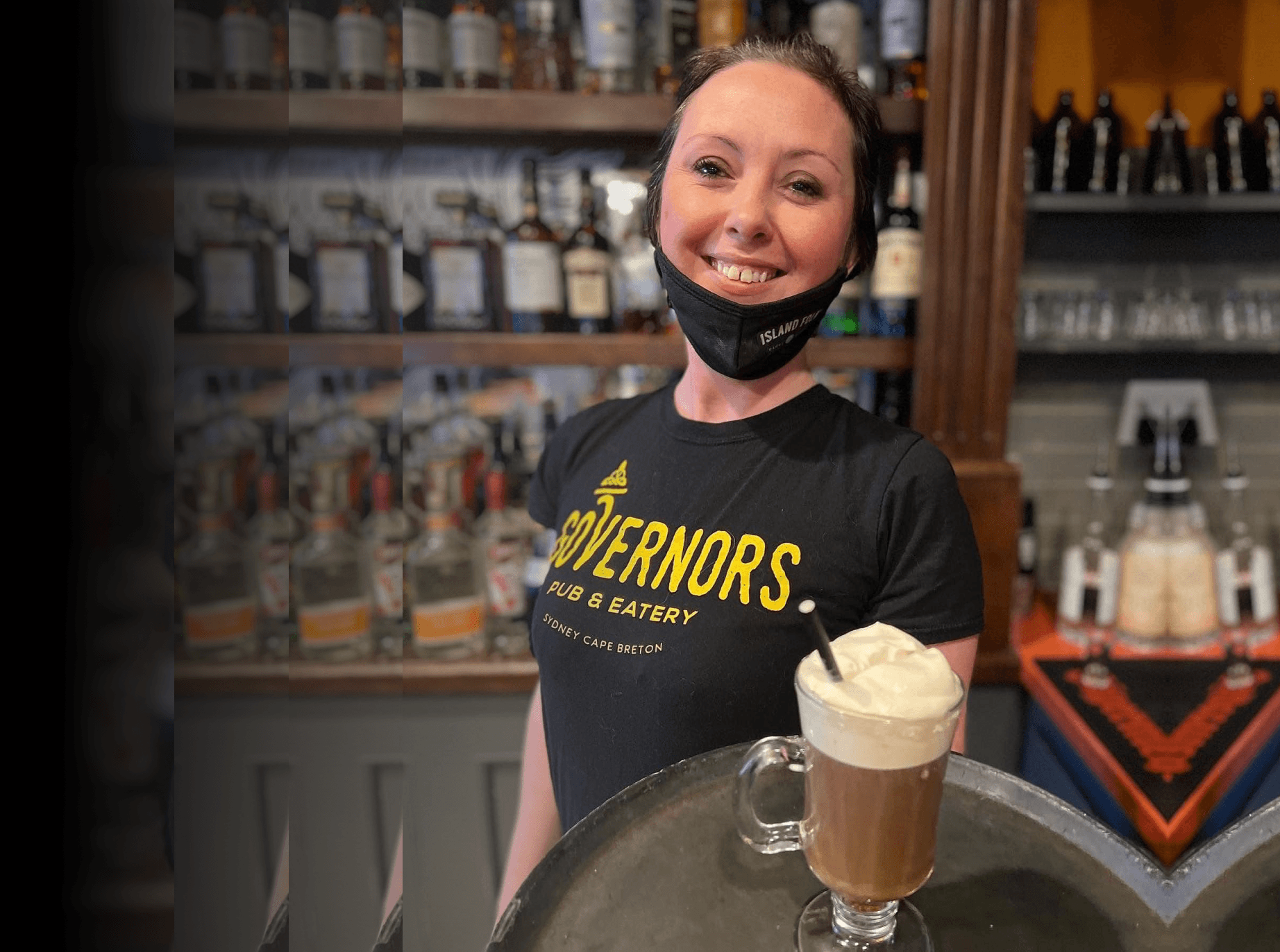 Bartender with mask serving whipped coffee