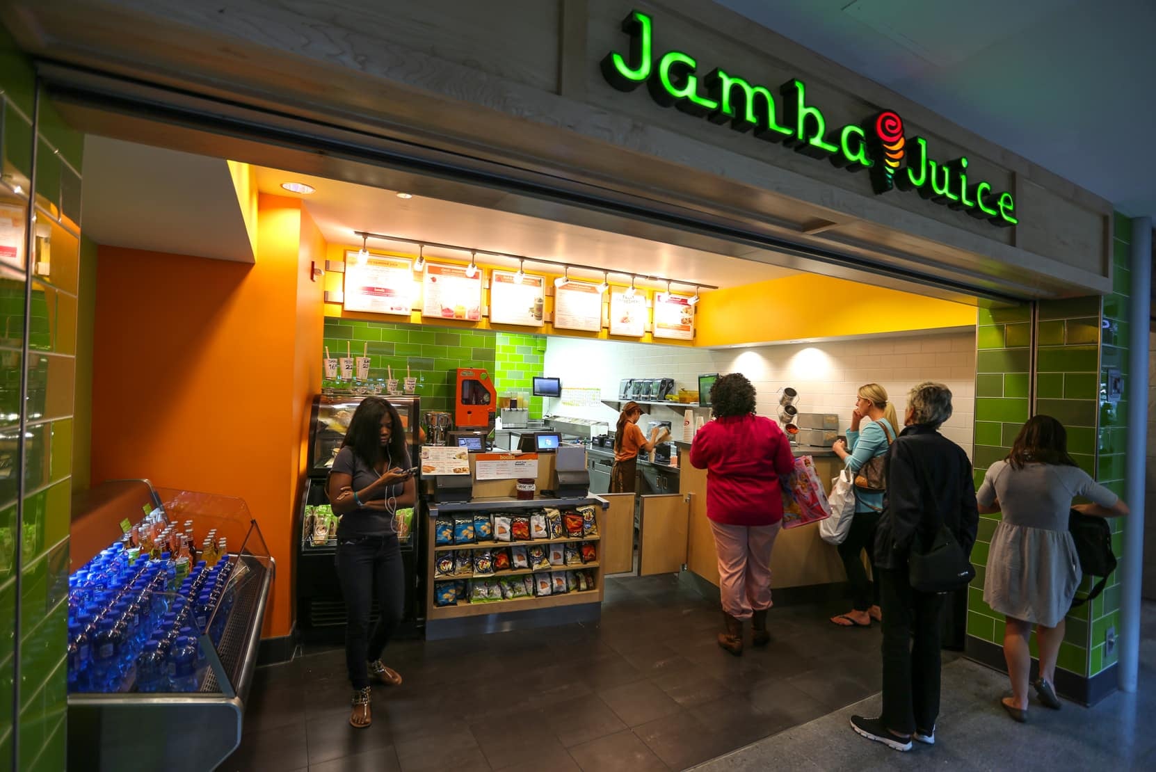 Customers at Jamba Juice store, ordering drinks.