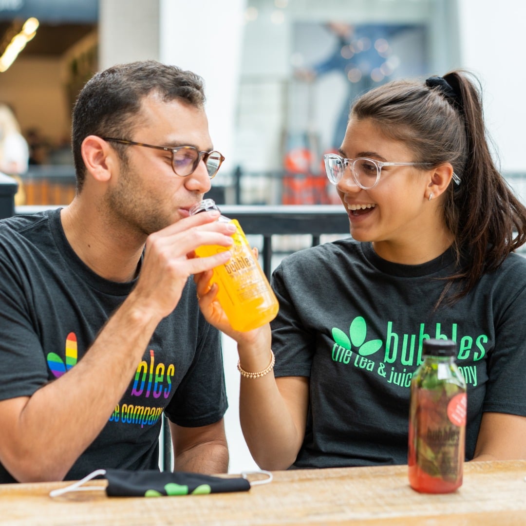 Couple enjoying bubble tea at a cafe.