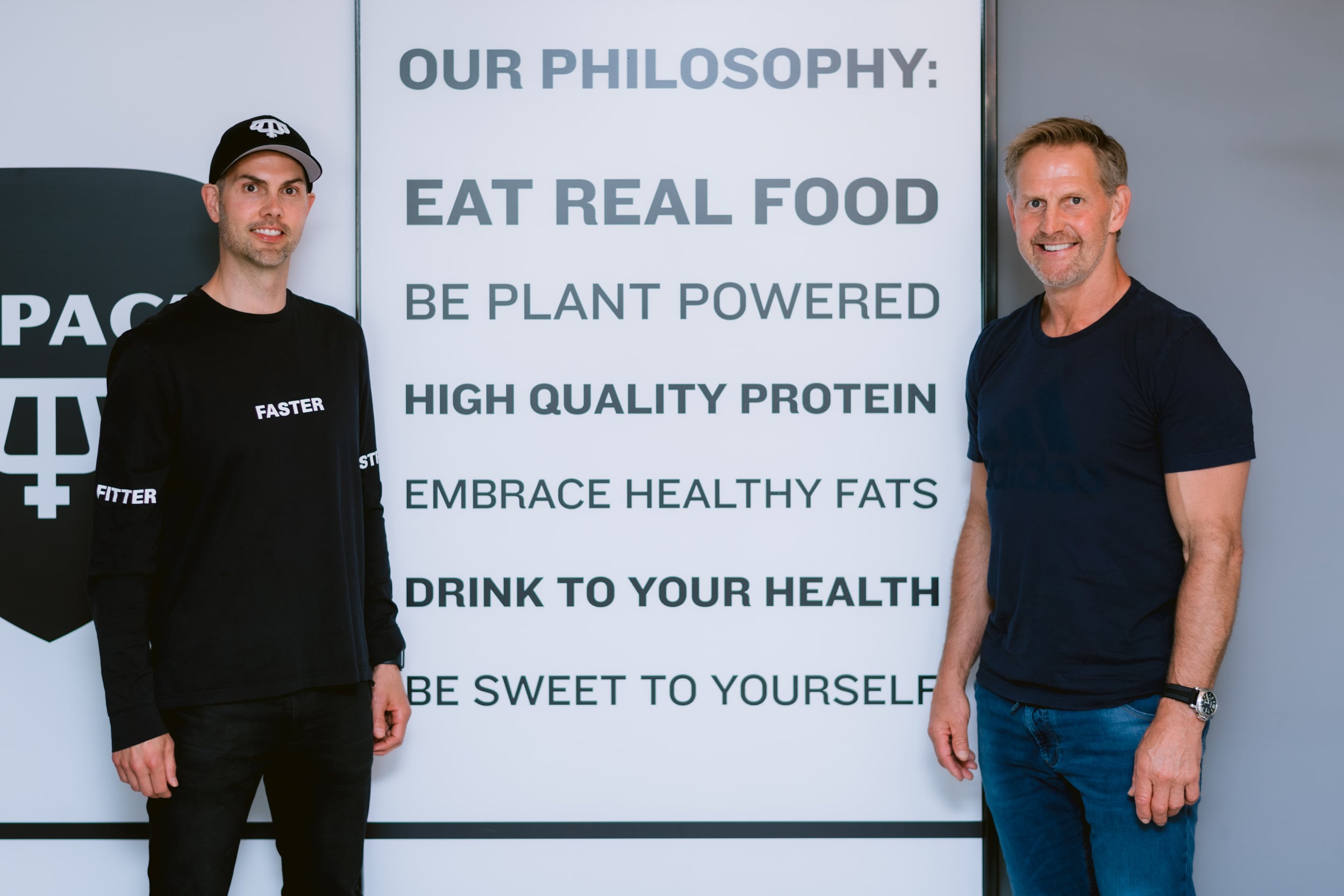 Two men promoting healthy eating philosophy.