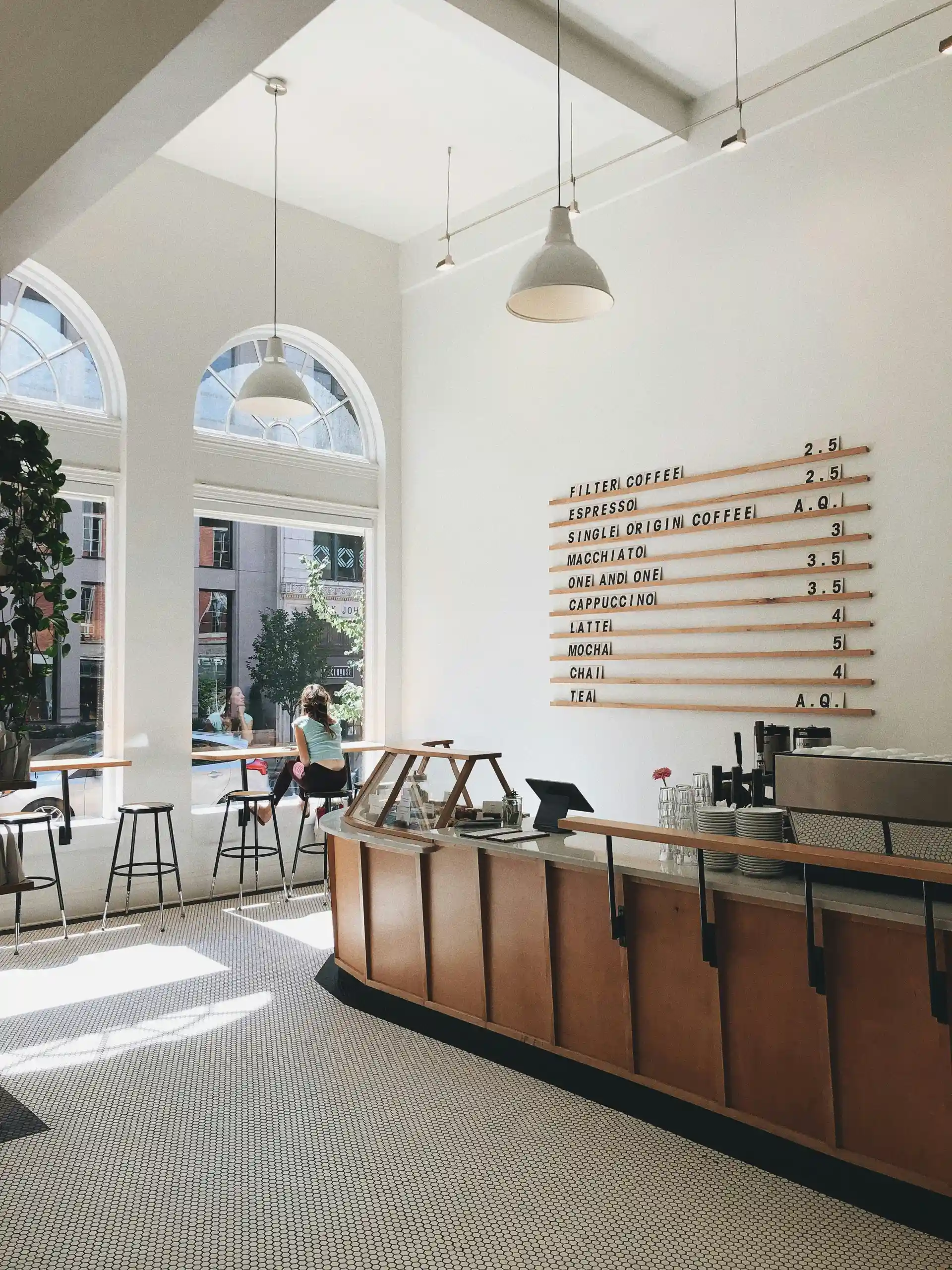 Bright coffee shop with menu and seating area.