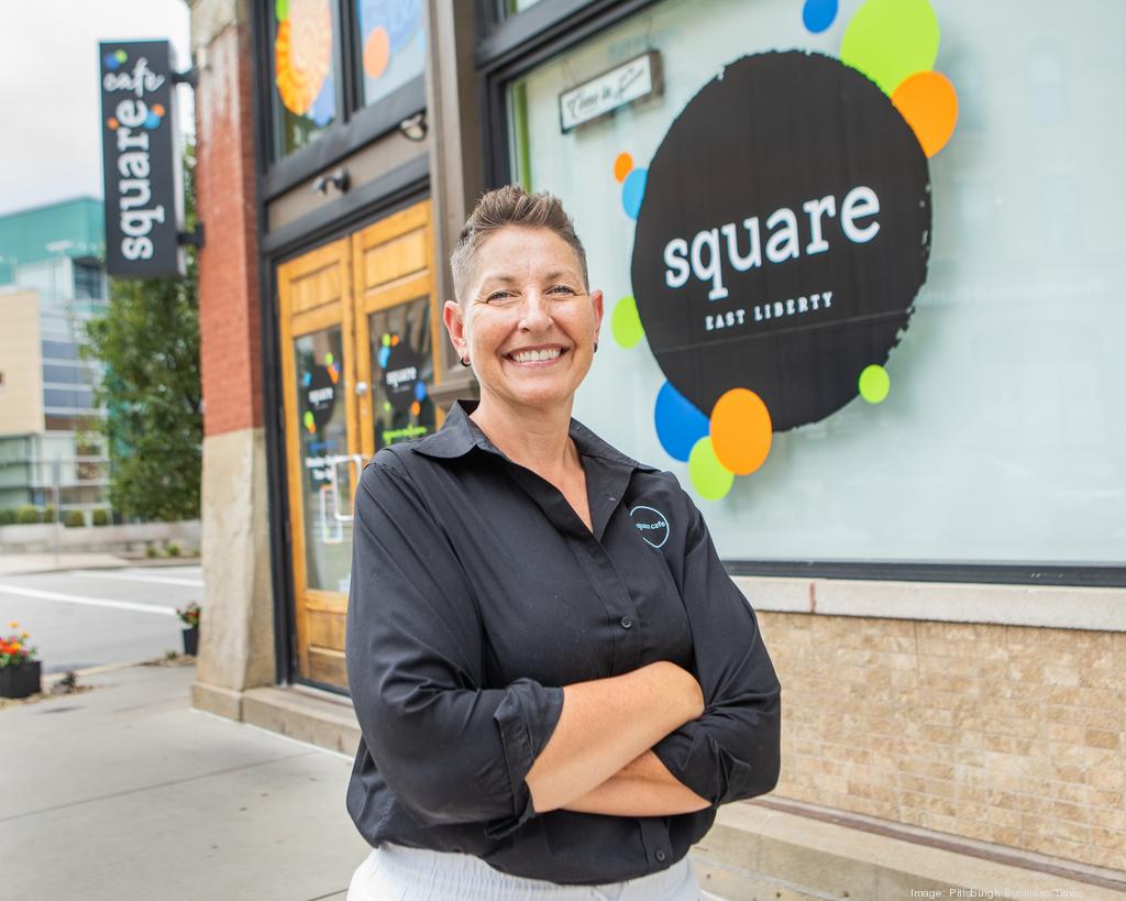 Person smiling outside Square Cafe, East Liberty location.