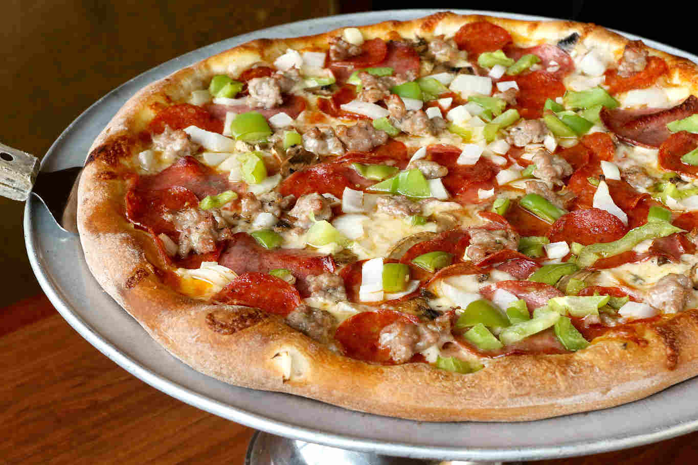 Pepperoni pizza with green peppers and onions.