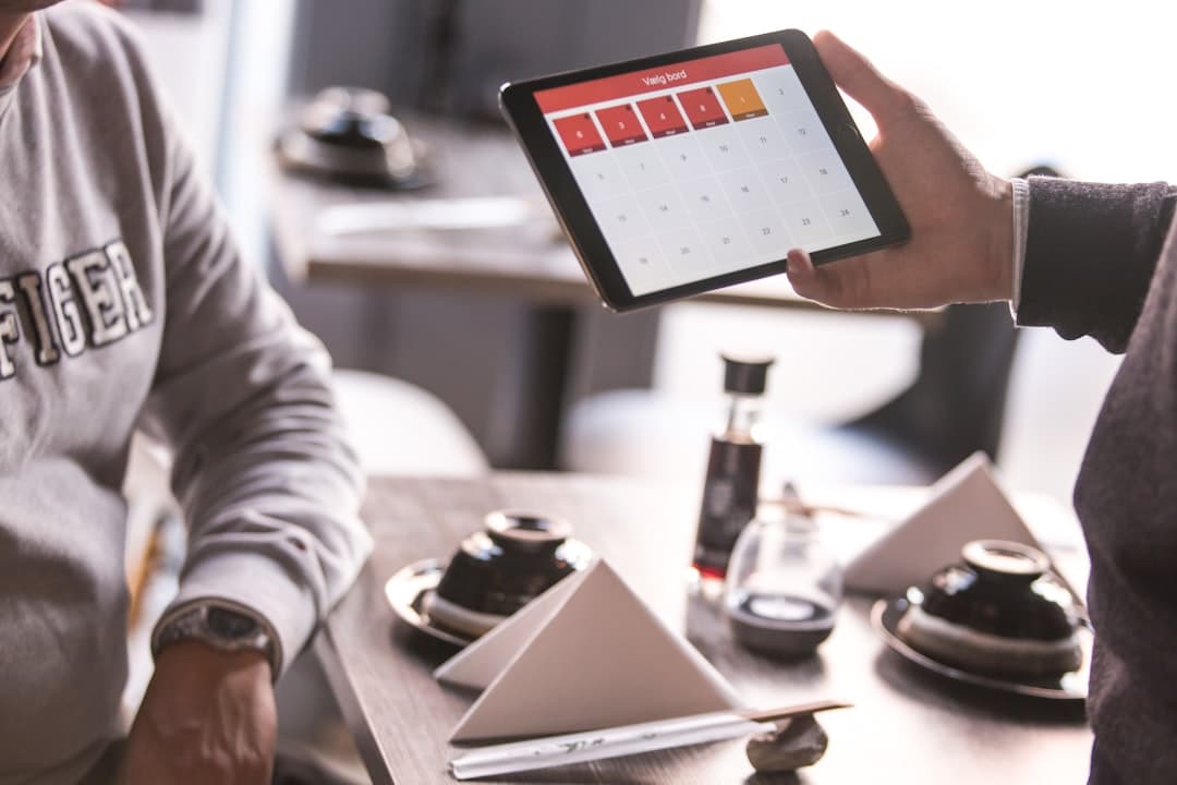 Person holding tablet at a restaurant table