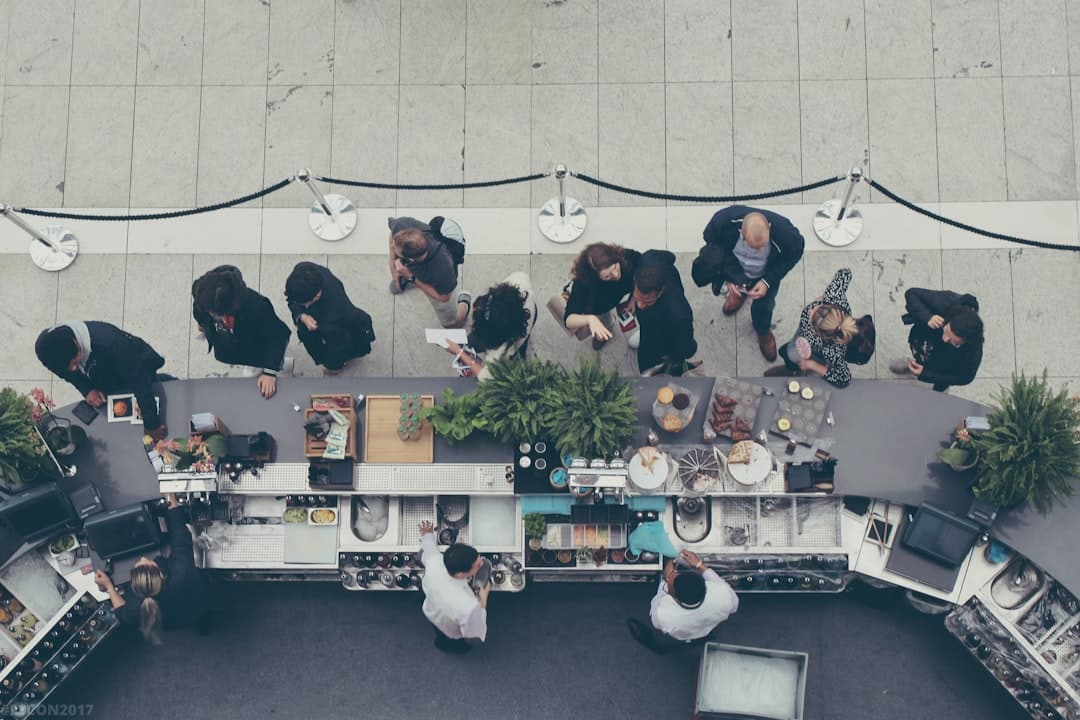 People lined up at outdoor cafe bar