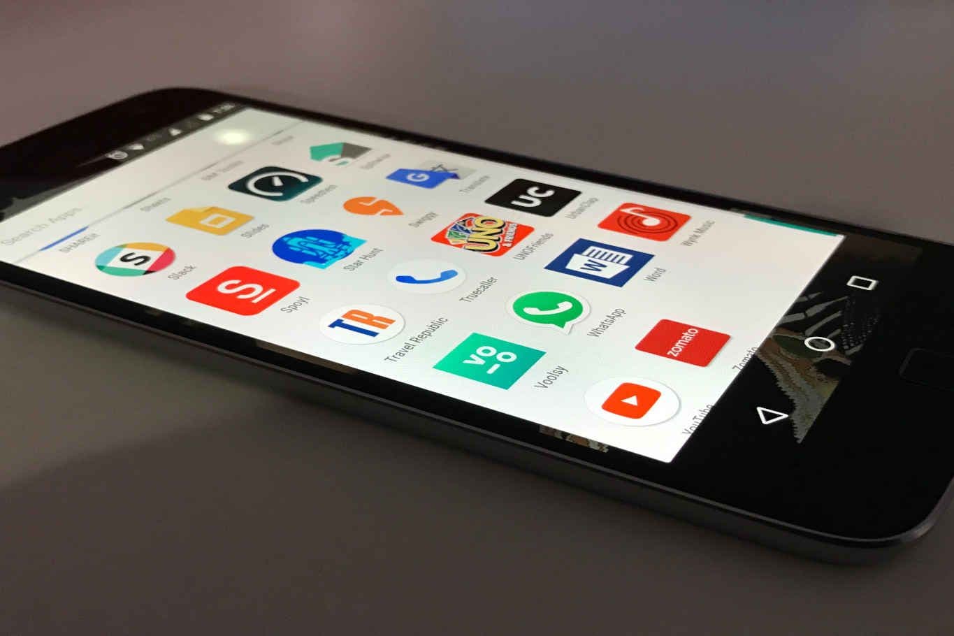 Smartphone displaying various app icons on screen.