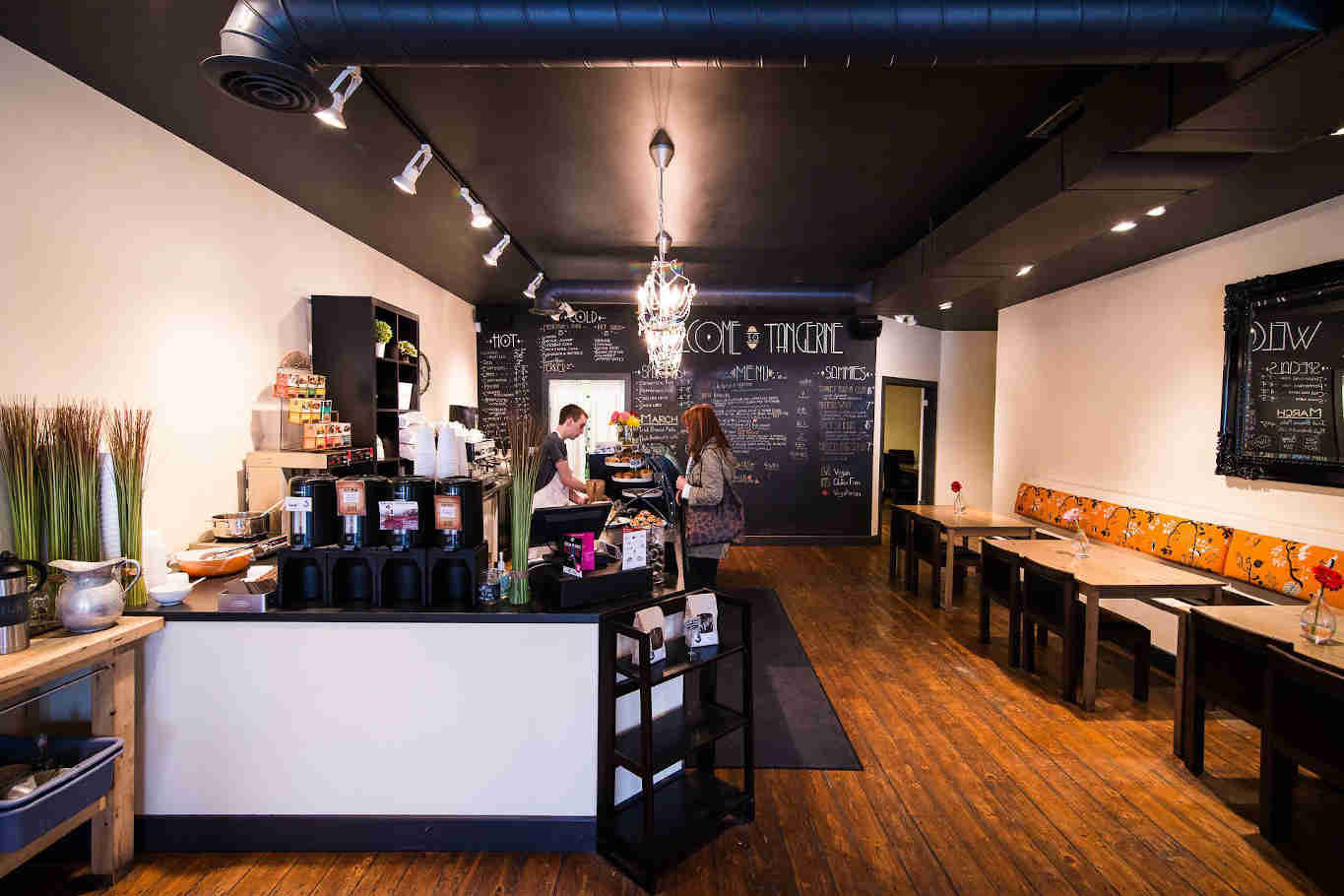 Cozy cafe interior with menu on chalkboard.