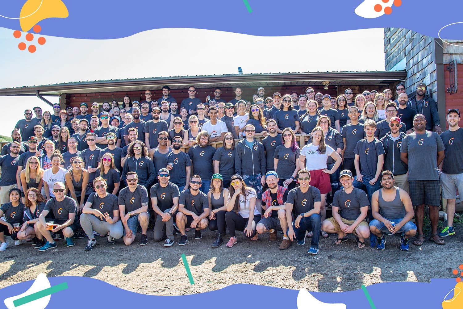 Large group of people posing outdoors.