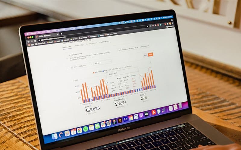 Laptop displaying financial data analytics graph.