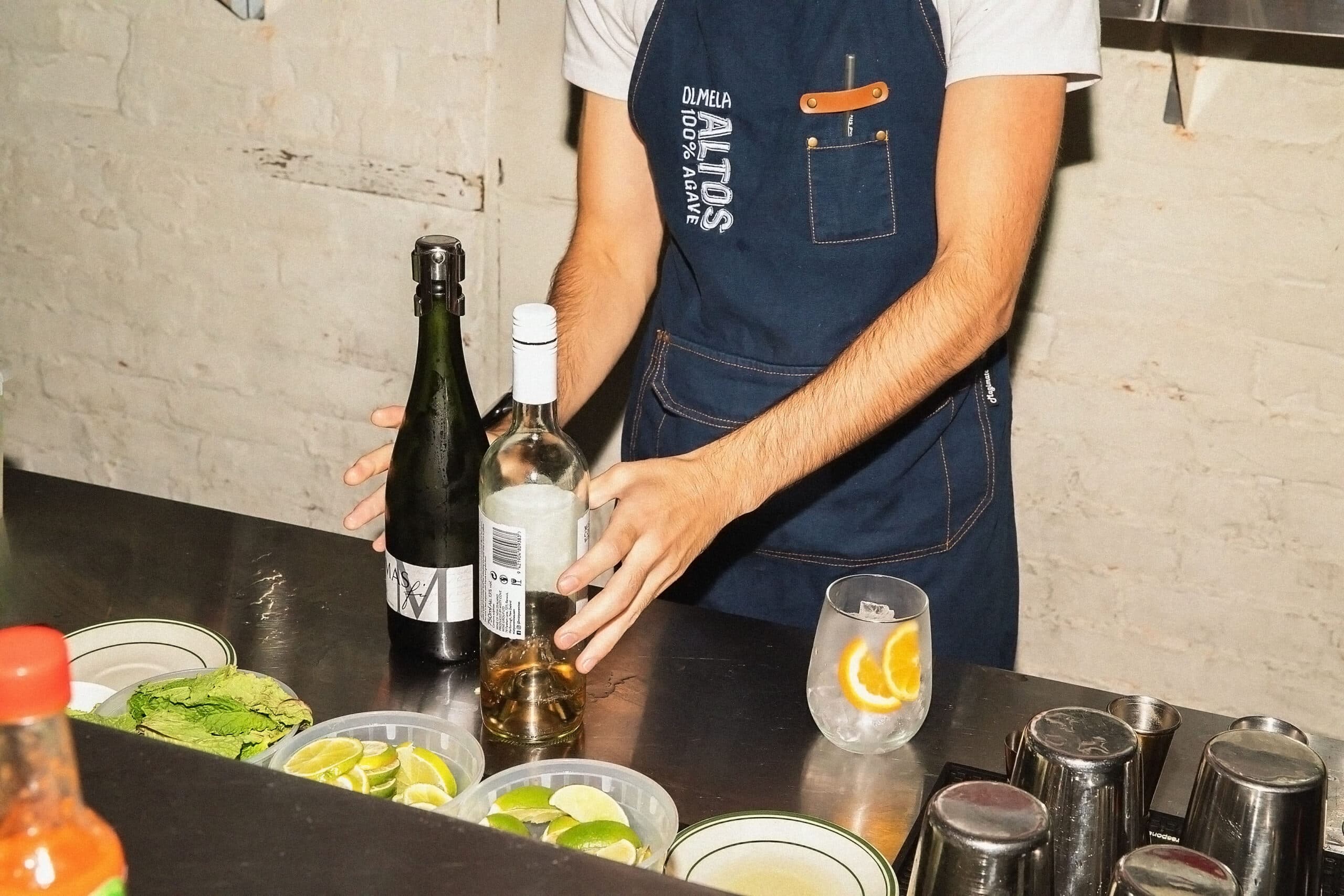 Bartender mixing drinks at restaurant bar