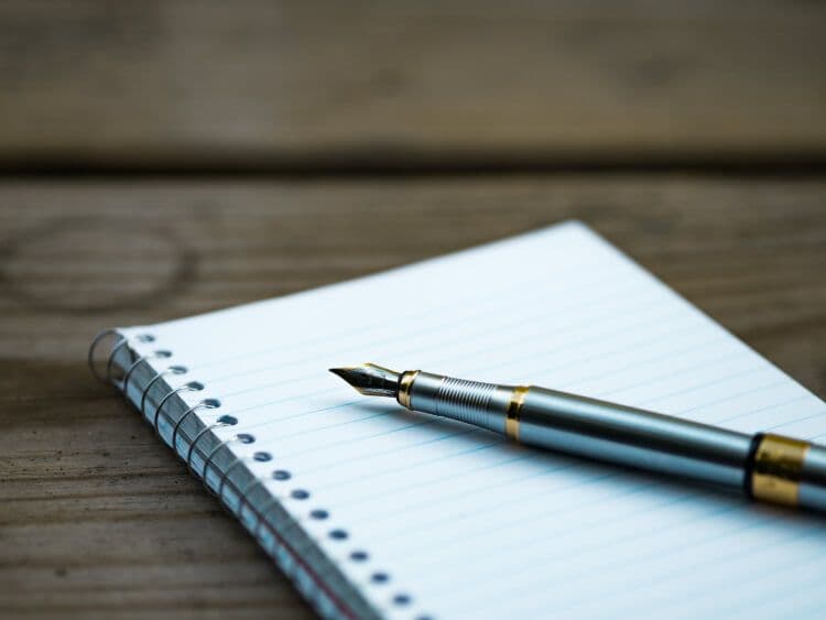 Fountain pen on spiral notebook