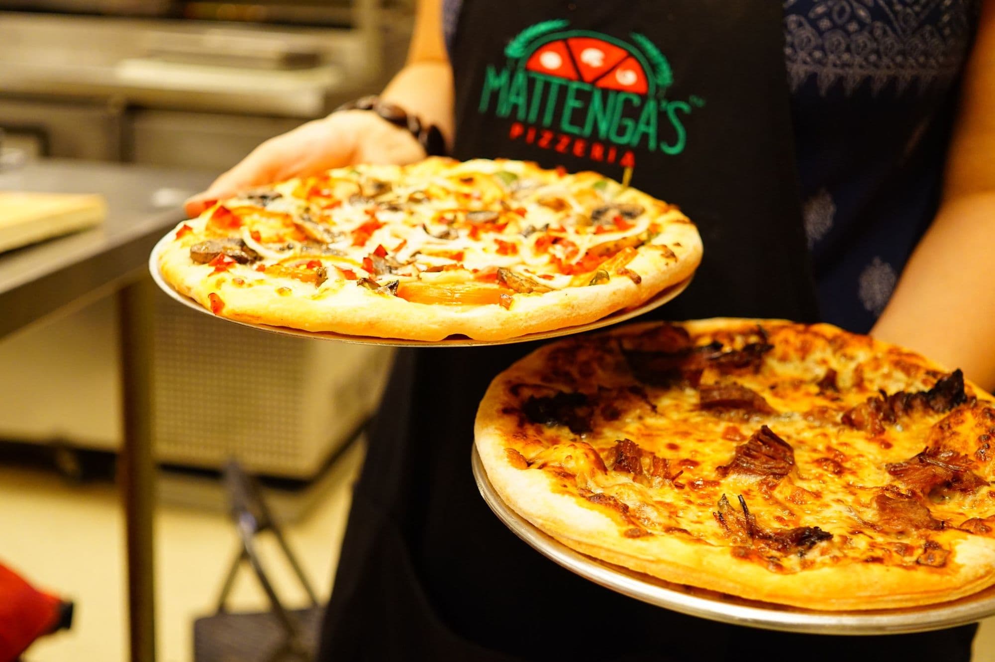 Delicious pizzas served in a pizzeria kitchen.