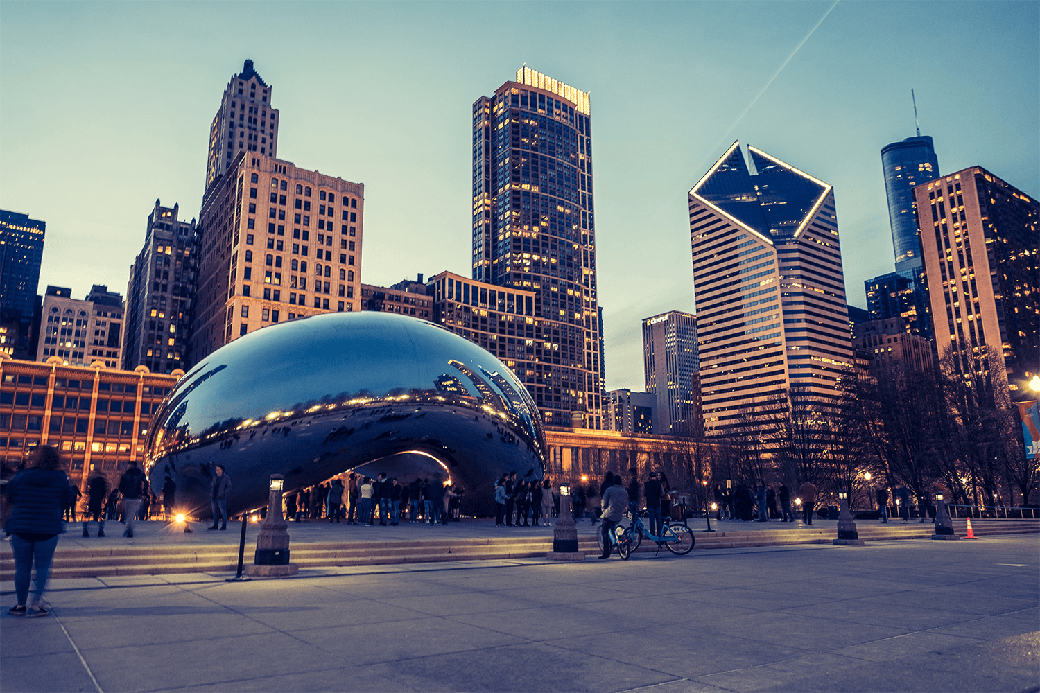 Chicago skyline with Cloud Gate sculpture at dusk.