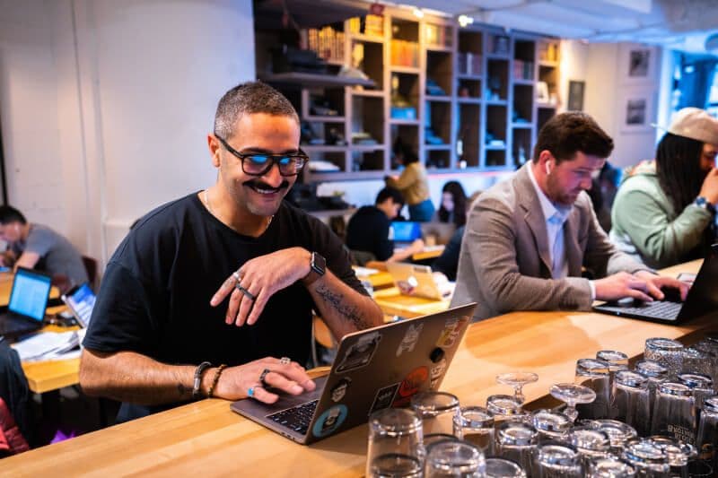 People working on laptops in a café.
