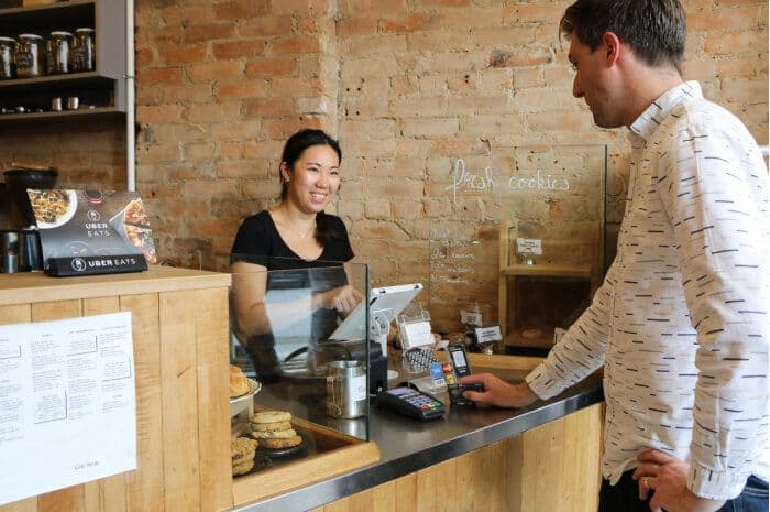 Customer paying at cafe counter with card