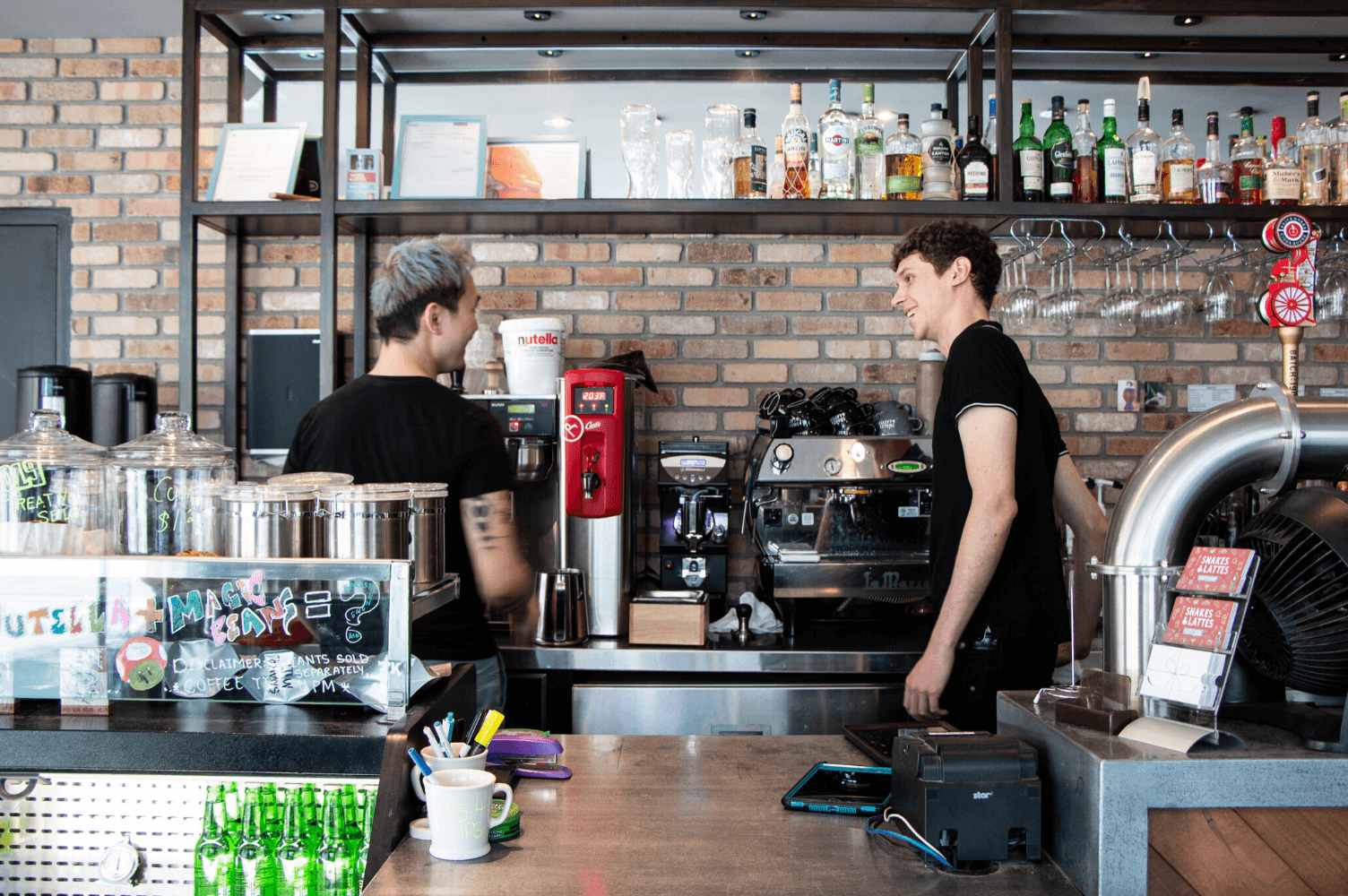 Baristas working at a modern cafe counter.