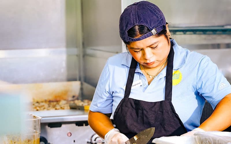 Chef preparing food in restaurant kitchen.