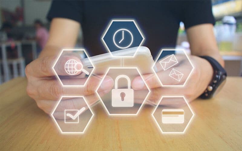 Person using smartphone with security icons overlay