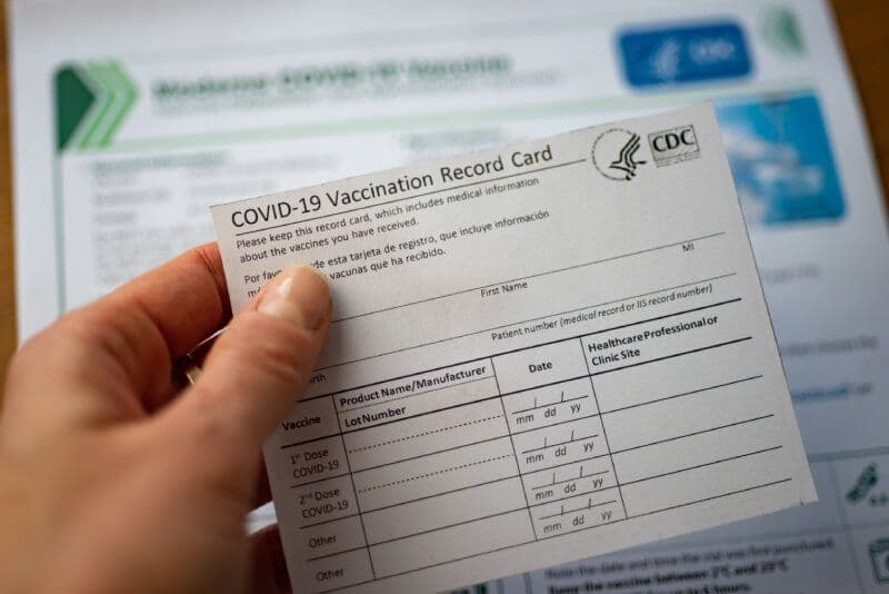 COVID-19 vaccination record card and instructions.