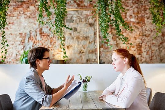 Two women having a meeting in a modern office.