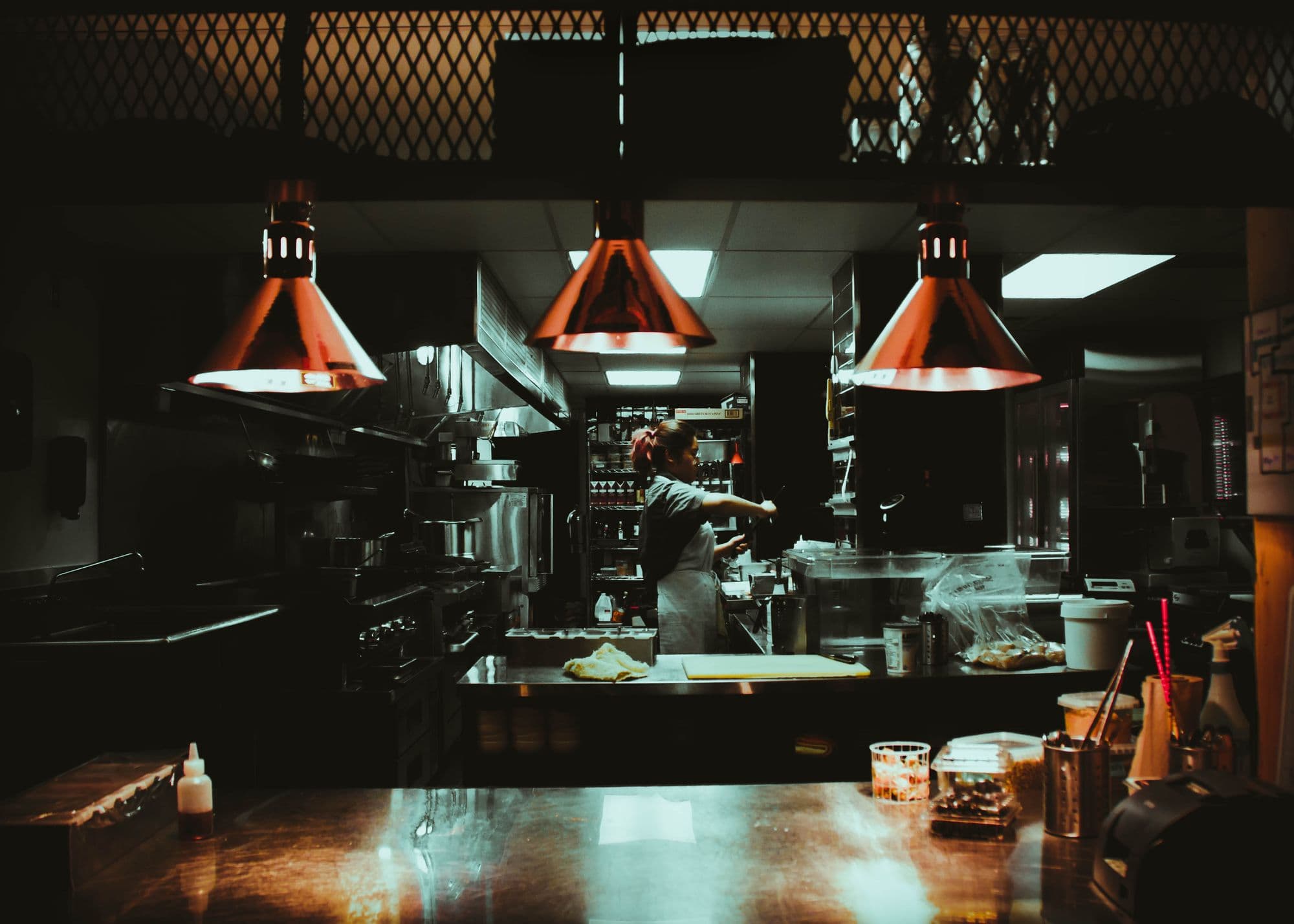 Chef preparing food in a restaurant kitchen.