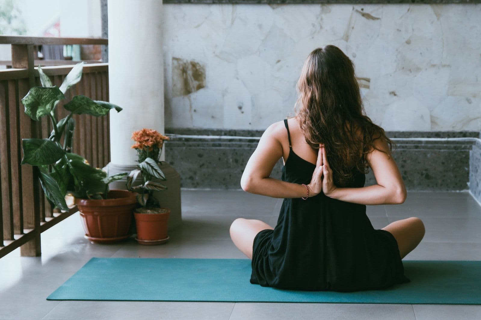 Woman practicing yoga on mat indoors