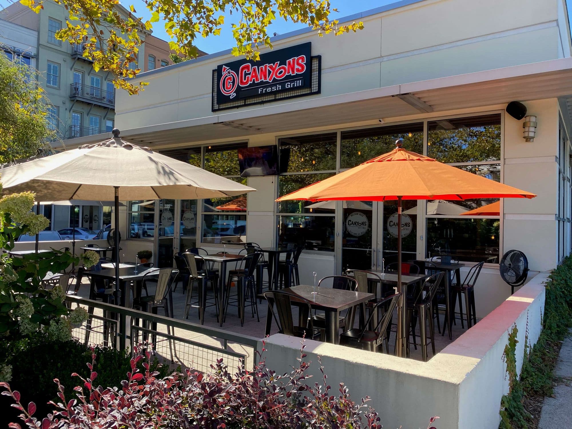 Outdoor restaurant seating under umbrellas.