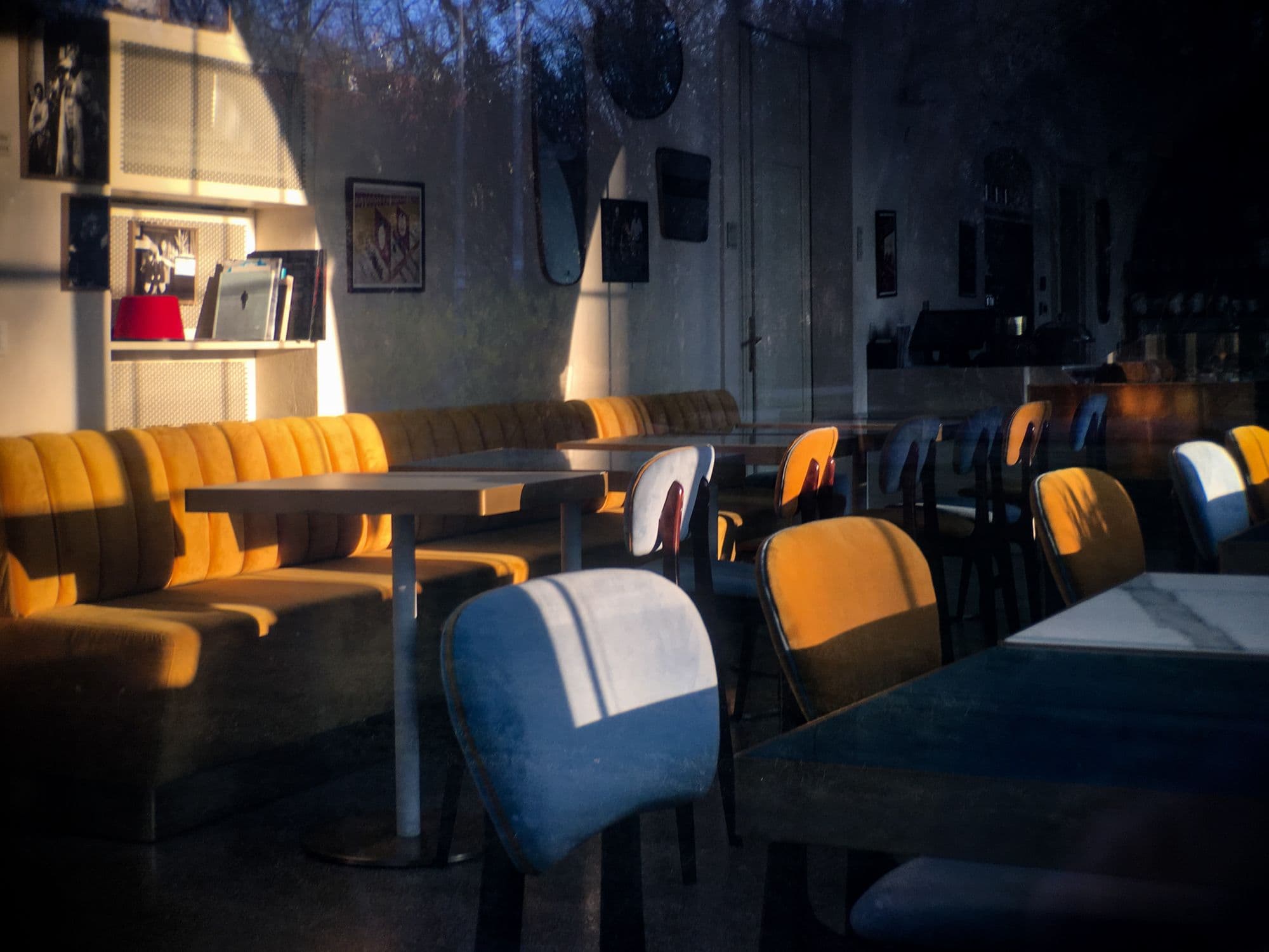 Empty cafe with colorful chairs and tables.