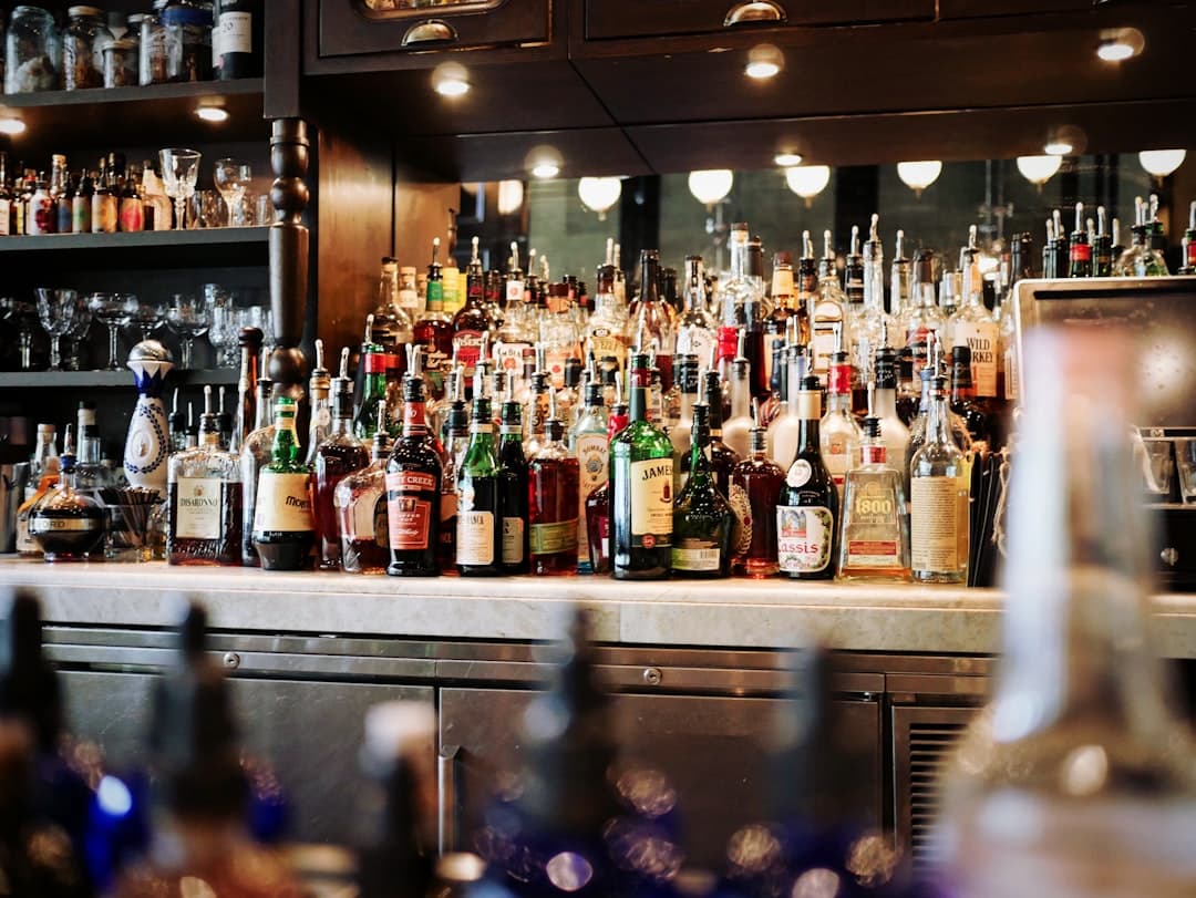 Bar shelves stocked with assorted liquor bottles.