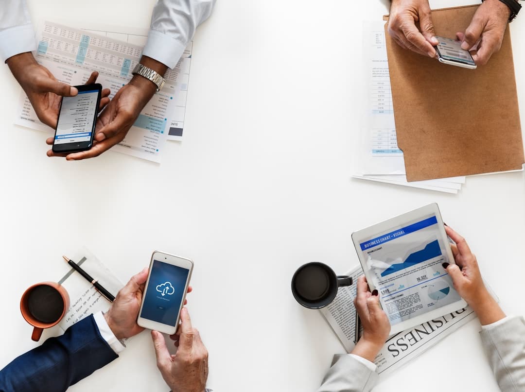 People using devices in business meeting