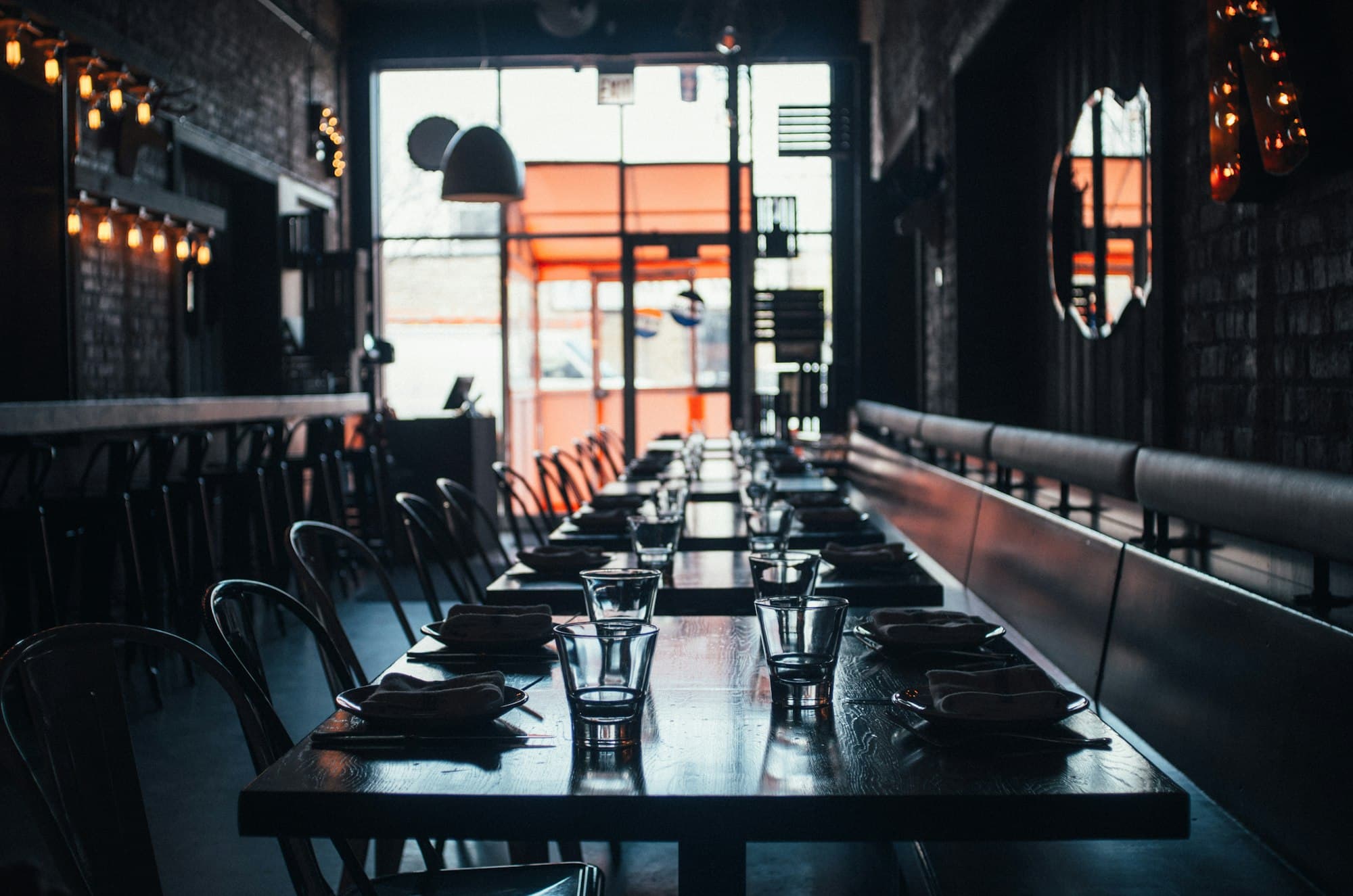 Empty restaurant with tables and chairs set.