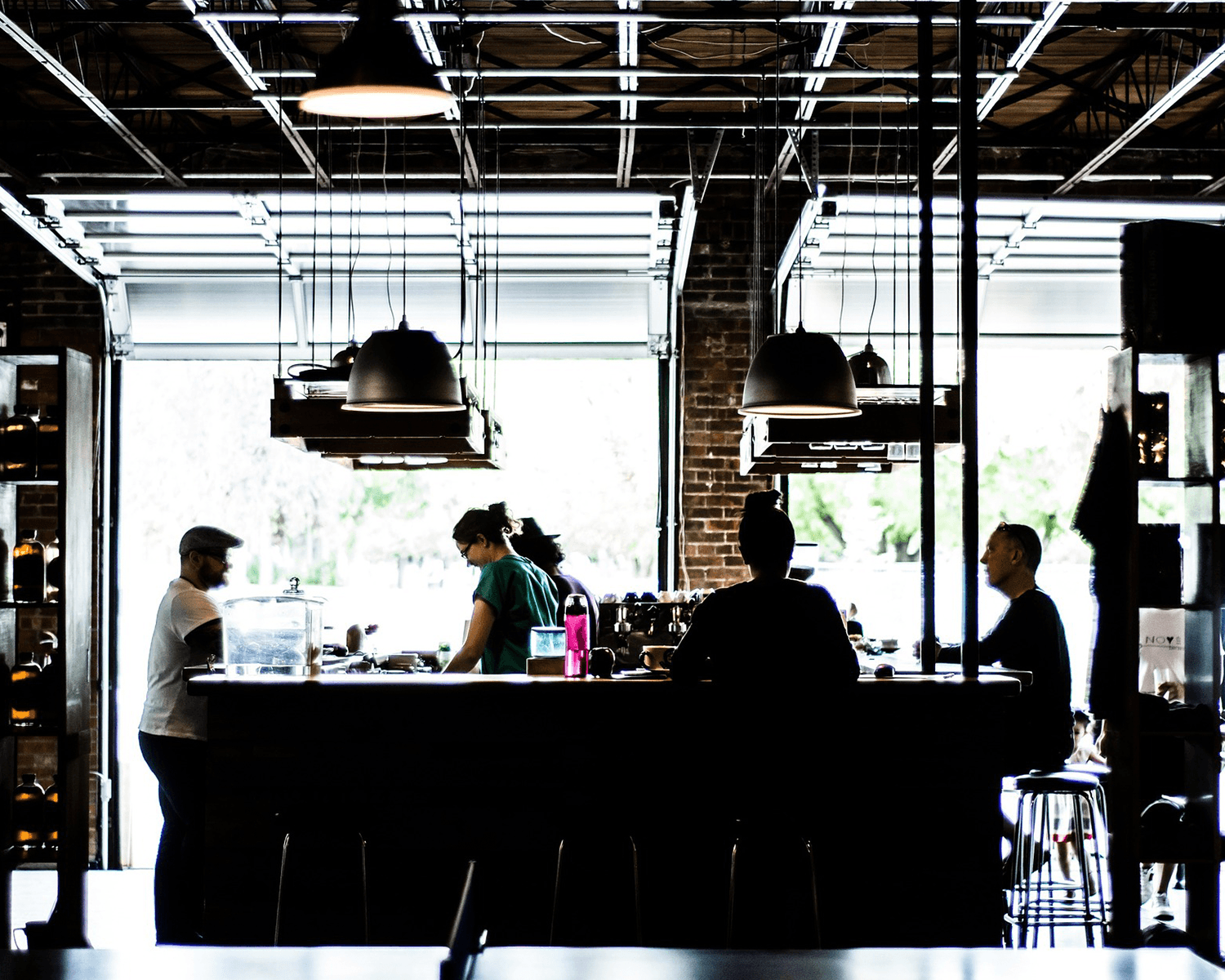 People working in a stylish café interior.