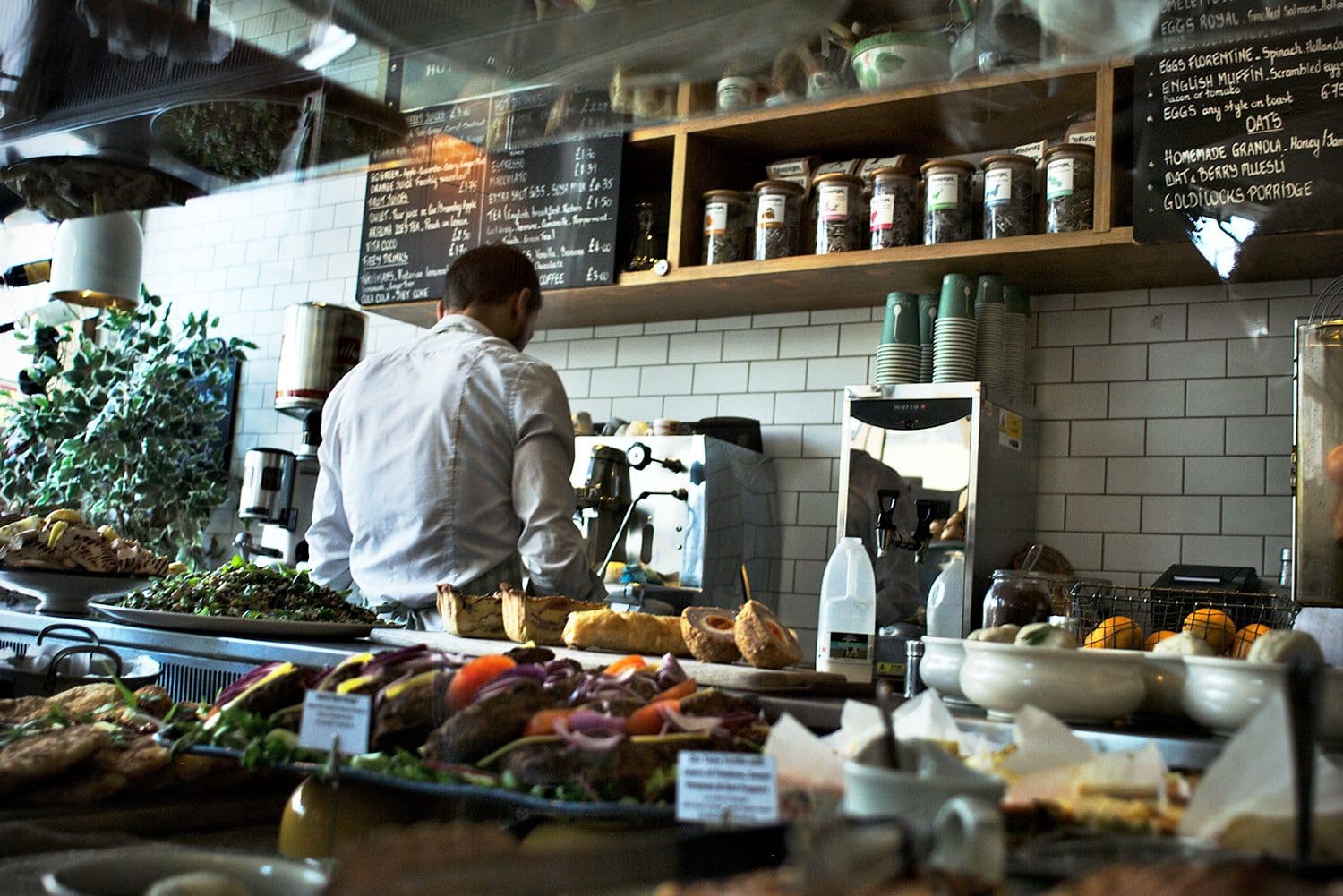 Barista preparing coffee in a busy cafe.