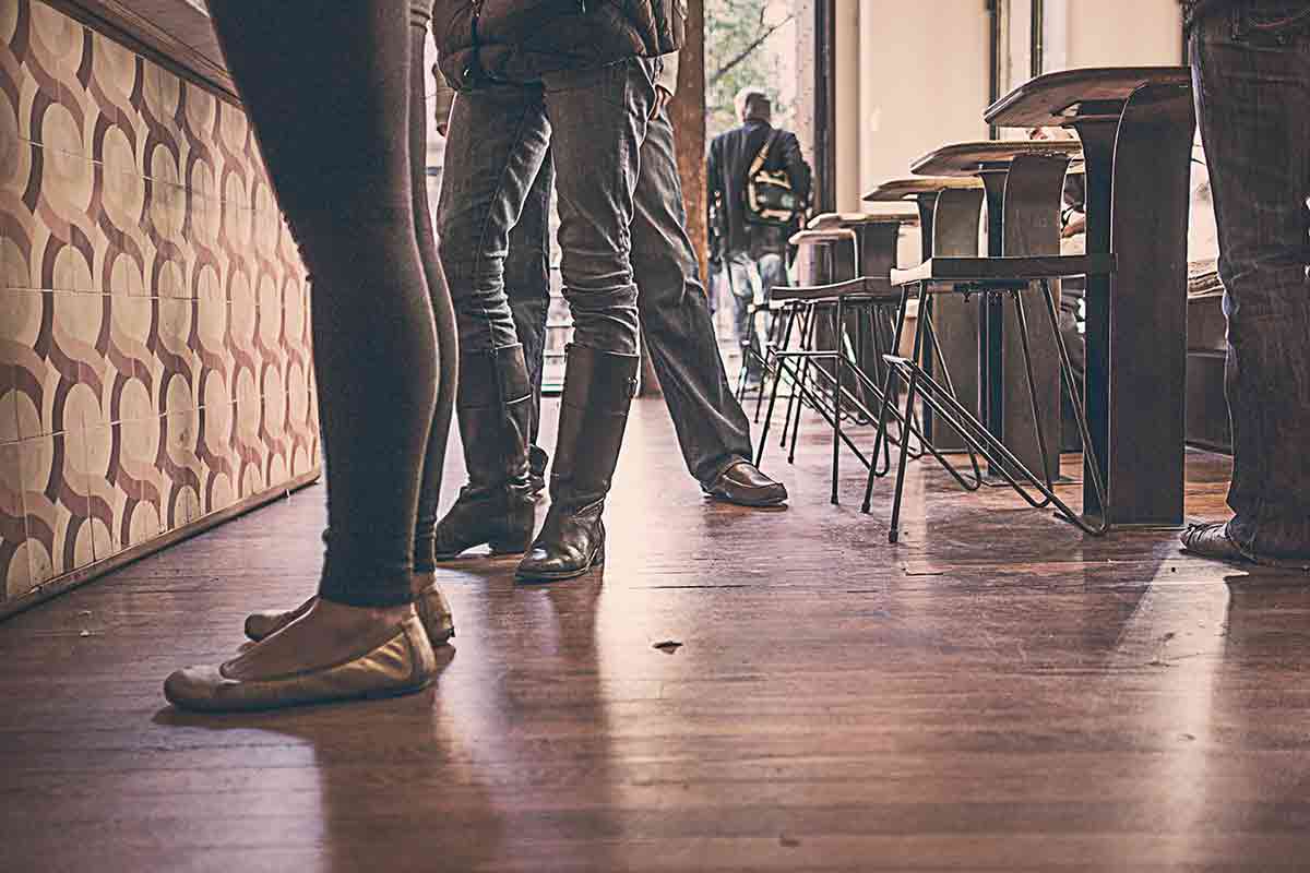 People standing in a casual coffee shop setting.