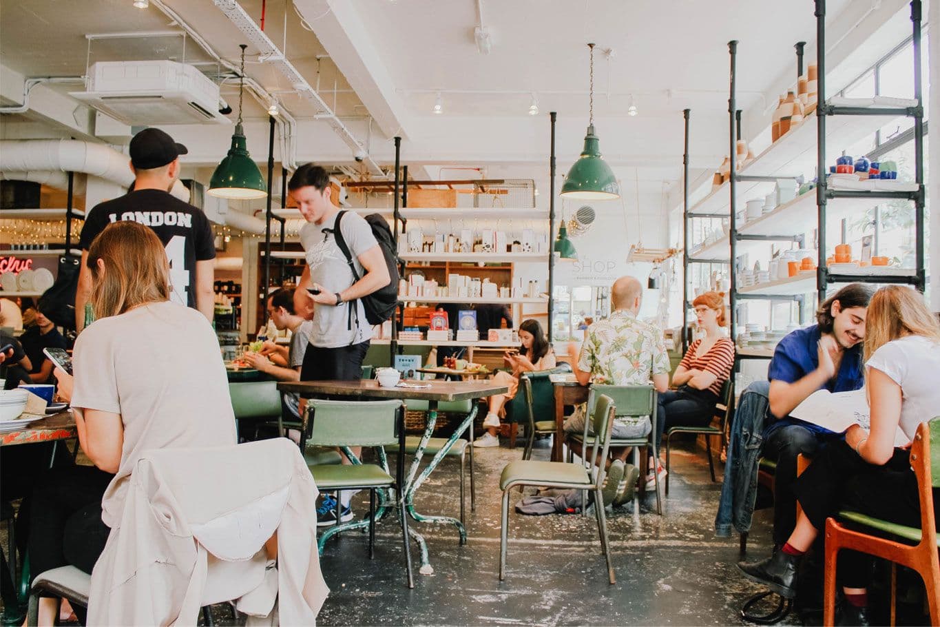 Busy cafe with people socializing and working.