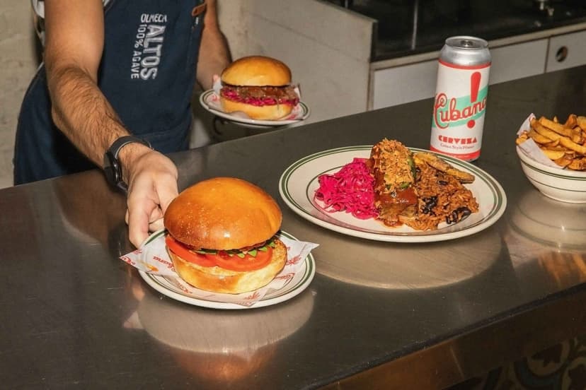 Restaurant meal: burger, rice, fries, drink on table.