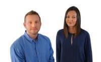 Two people posed against a white background.