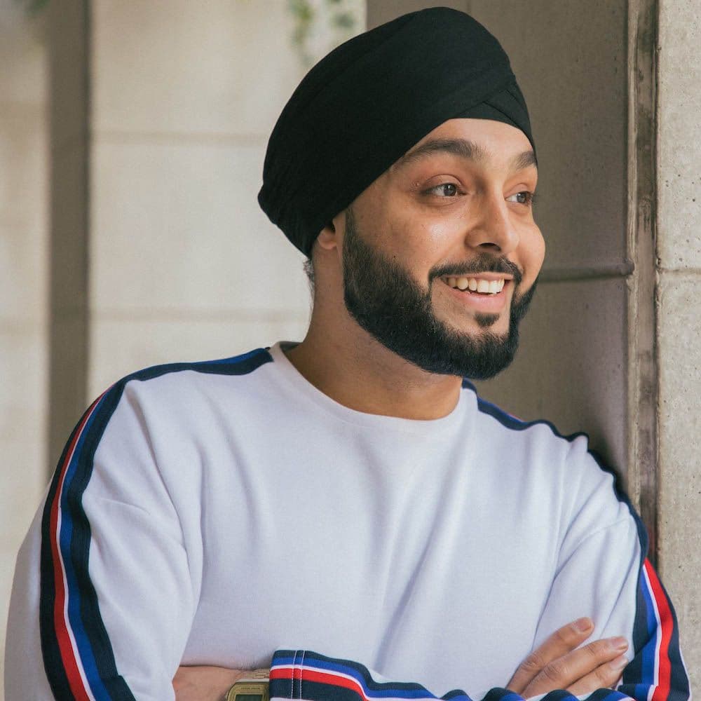 Smiling man in turban by a window