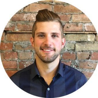 Smiling person with brick wall background, circular frame