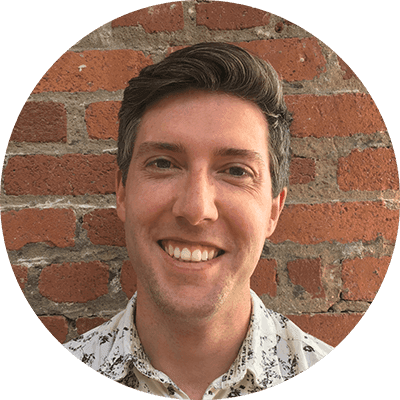 Smiling person with brick wall background