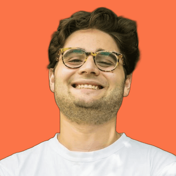 Smiling person with glasses on orange background.